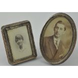 An early 20th century rectangular silver photograph frame, together with a similar oval example,