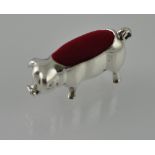 A white metal pin cushion in the form of a pig, stamped 925.