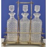 A Victorian silver plated three bottle tantalus by R Richardson, Sheffield, fitted with square cut