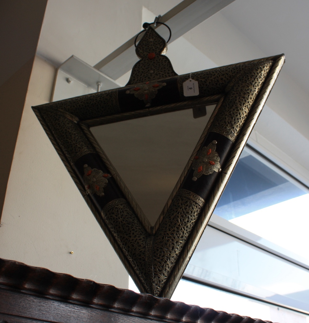 A Moroccan triangular wall mirror with finely pierced metal mounted frame.