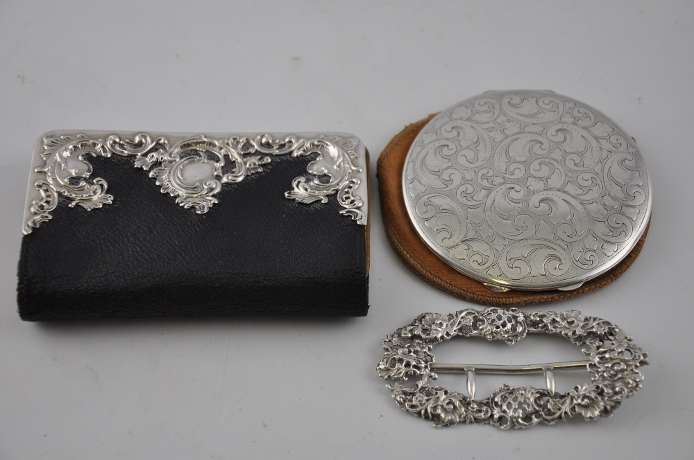 An Edwardian black leather purse, with white metal fittings stamped sterling silver, together with