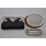 An Edwardian black leather purse, with white metal fittings stamped sterling silver, together with