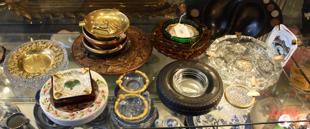 A collection of assorted ceramics, glass and wood ashtrays.