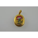 A yellow metal and enamel locket, oval on a shaped bale, decorated with a carnation set with