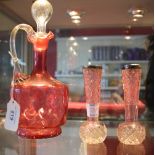 A late Victorian cranberry glass liqueur decanter and stopper, three cranberry frill neck dishes, a