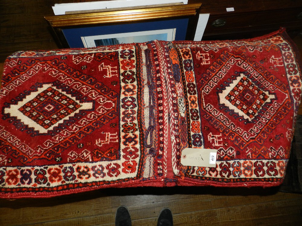 A pair of Middle Eastern woolen Camel bags, having geometric central medallions.