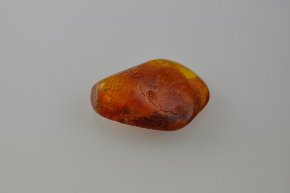 An asymmetrical amber deposit with inclusions, 9g.