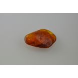 An asymmetrical amber deposit with inclusions, 9g.