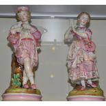 A pair of late 19th Century porcelain figural stem holders, modelled as a boy feeding a rabbit and