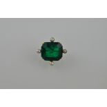 A green gemstone and pearl set brooch, possibly emerald, the trap-cut stone claw set with pearls at