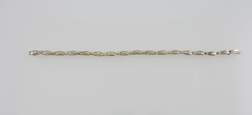 An 18ct gold diamond line bracelet, with baguette oval links, total weight 2ct, L. 19cm.