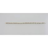 An 18ct gold diamond line bracelet, with baguette oval links, total weight 2ct, L. 19cm.