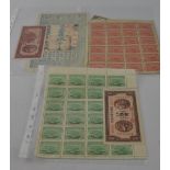 Two sheets of early 20th century Chinese stamps, together with a cheque and paper money.