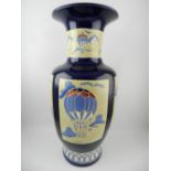 A large baluster vase, decorated with vignettes of air balloons, on a dark blue ground. H.51cm