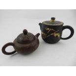 A Chinese Yixing teapot, together with one other Chinese teapot.