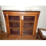 A mid Victorian walnut and parcel ebonised pier cabinet, fitted a pair of glazed cupboard doors,