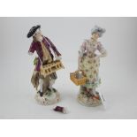 A pair of early 20th century Dresden porcelain figural studies of flower sellers. H.18cm