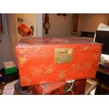 A Chinese red lacquer style miniature chest. H.20cm W.42cm