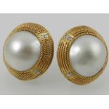 A pair of yellow metal diamond and pearl set ear studs.