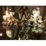 A large collection of Staffordshire pottery figural studies including a watch stand and sundry