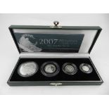 A collection of silver proof Britannia coins, including 1997, 2001, 2003, and 2007.