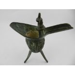 A 15th / 16th century style Chinese bronze oil ewer, on tripod base. H.16cm