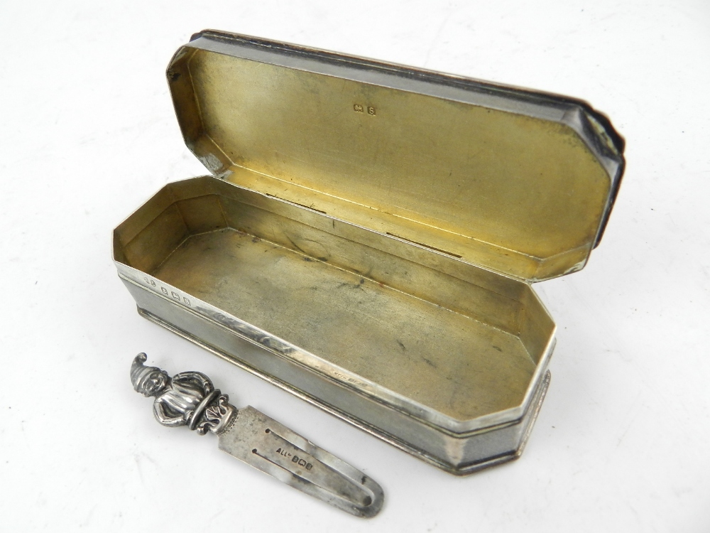 An early 20th century silver pin box, together with a silver page marker with punch terminal.