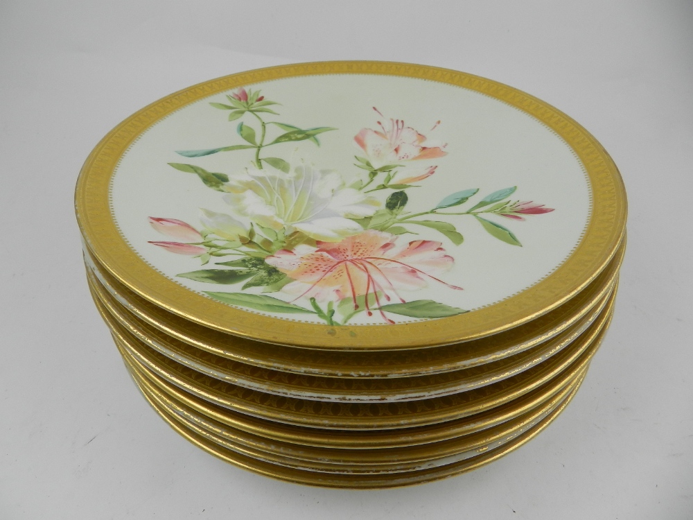 A Aynsley porcelain dessert service, painted with flowers to centre, having gilt rim.