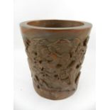 A Chinese carved wooden brush pot, having continuous decoration of figurines in landscape.
