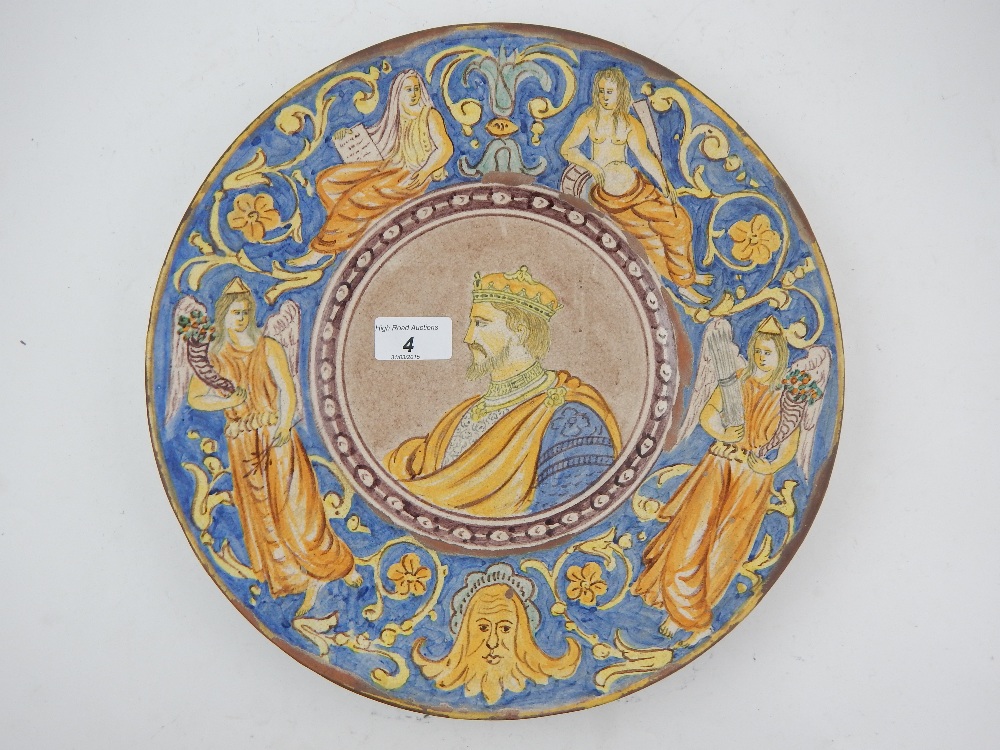 A 19th century Italian majolica charger, centered with a profile portrait of a King, within foliate