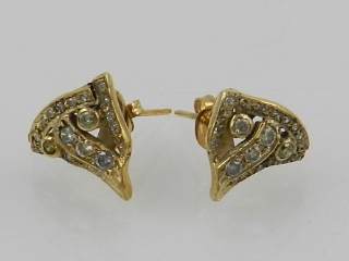 A pair of yellow metal and diamond set stud earrings.