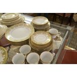 A Noritake Lucerne patterned dinner and coffee service, having green and gilt continuous decoration