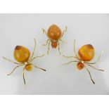 Three yellow metal and amber style brooches modelled as a beetles