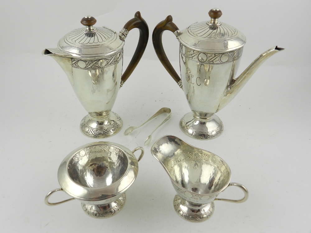 Liberty & Co. An Arts and Crafts five piece silver tea service, having foliate scroll engraved