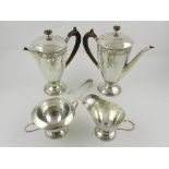 Liberty & Co. An Arts and Crafts five piece silver tea service, having foliate scroll engraved