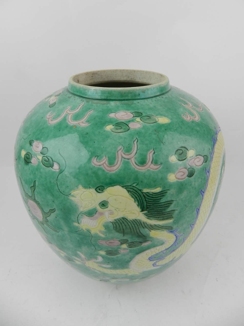 A 19th century Chinese hard paste porcelain vase, decorated on a green ground with dragons chasing