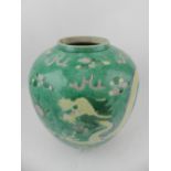 A 19th century Chinese hard paste porcelain vase, decorated on a green ground with dragons chasing