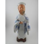 A late 19th/ early 20th century porcelain figural study of an elder, having removable head. H.38cm