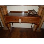 A 1920's oak side table in the mid 18th century style, fitted two drawers raised on cabriole legs,