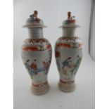 A pair of Chinese Canton porcelain inverted baluster vases in colours, decorated with figures