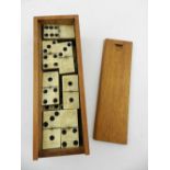 A cased bone and wood Dominos game set