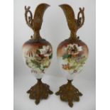 A pair of Worcester style ormolu mounted ornamental ewers, painted with flowers and foliage, H.45cm