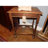 A 1920's oak rectangular occasional table, raised on turned supports.