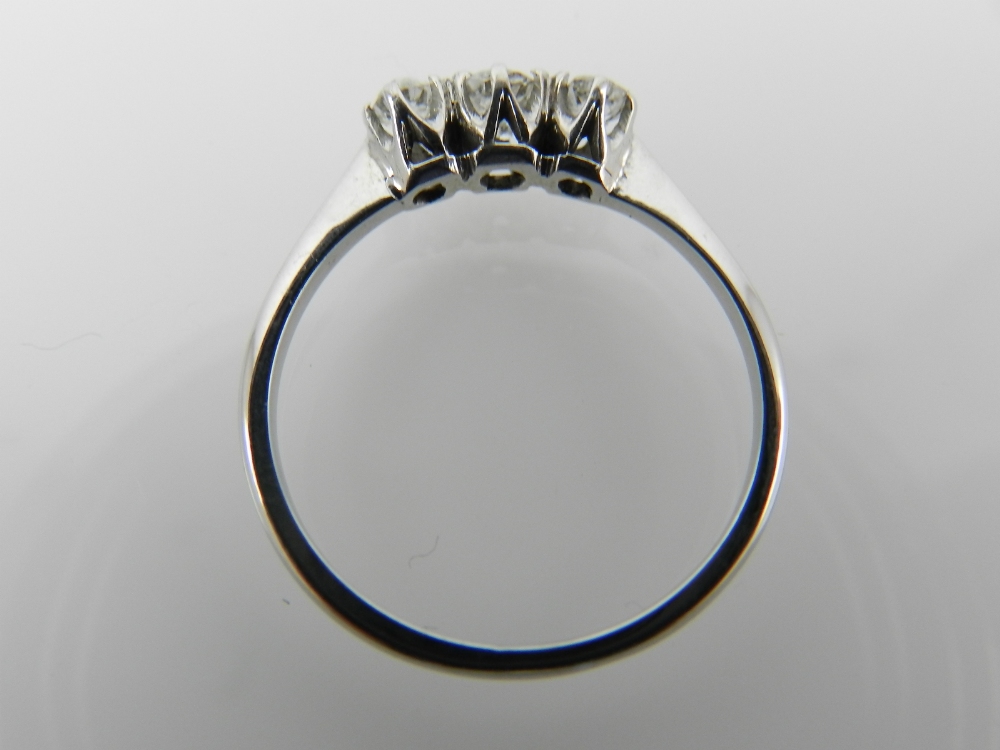 A white metal three stone diamond ring, - Image 2 of 2