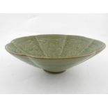 A Chinese Long Yuan celadon bowl, decorated with foliage and figures to interior.