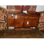 A George IV mahogany sideboard, having a 3/4 gallery top, above two drawers with two cupboard