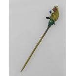 An unusual painted base metal tie pin, fashioned as a seated monkey.