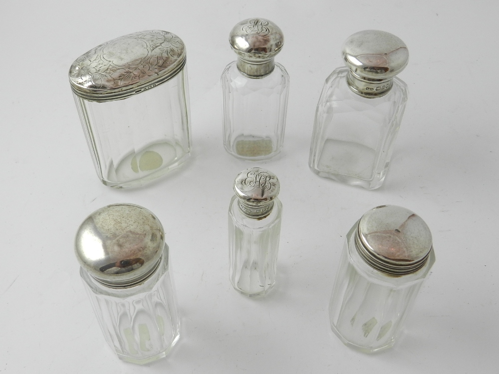 A collection of six 20th century silver topped glass bottles, one hallmarked Walker & Hall