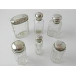 A collection of six 20th century silver topped glass bottles, one hallmarked Walker & Hall