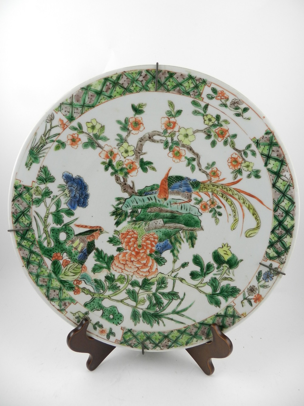An early 20th century Canton porcelain wall charger, decorated in the famille verte pallet with